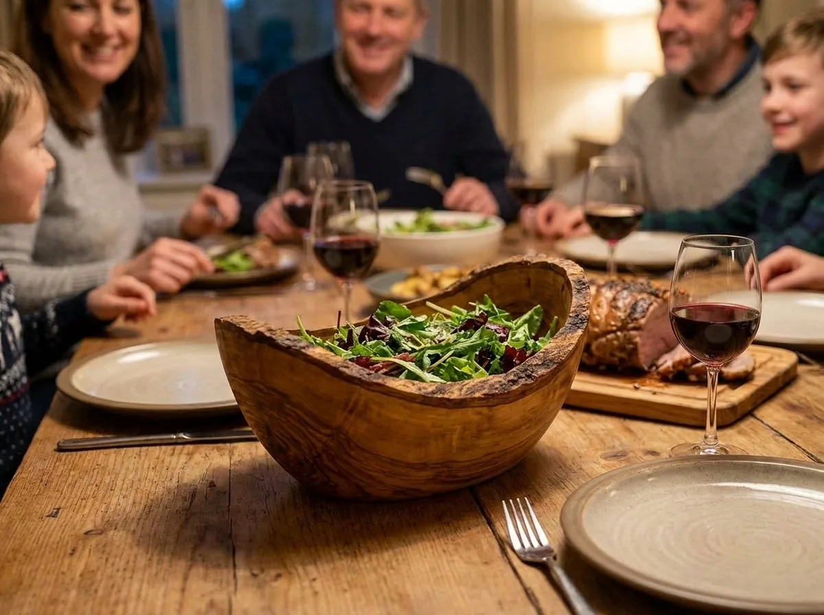 The olive wood bowl on a laid family dinner table